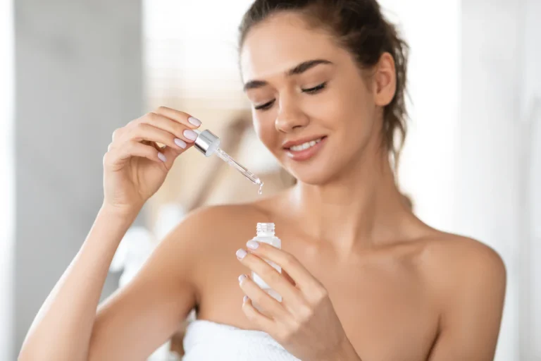 Attractive Lady Applying Facial Serum 1100x